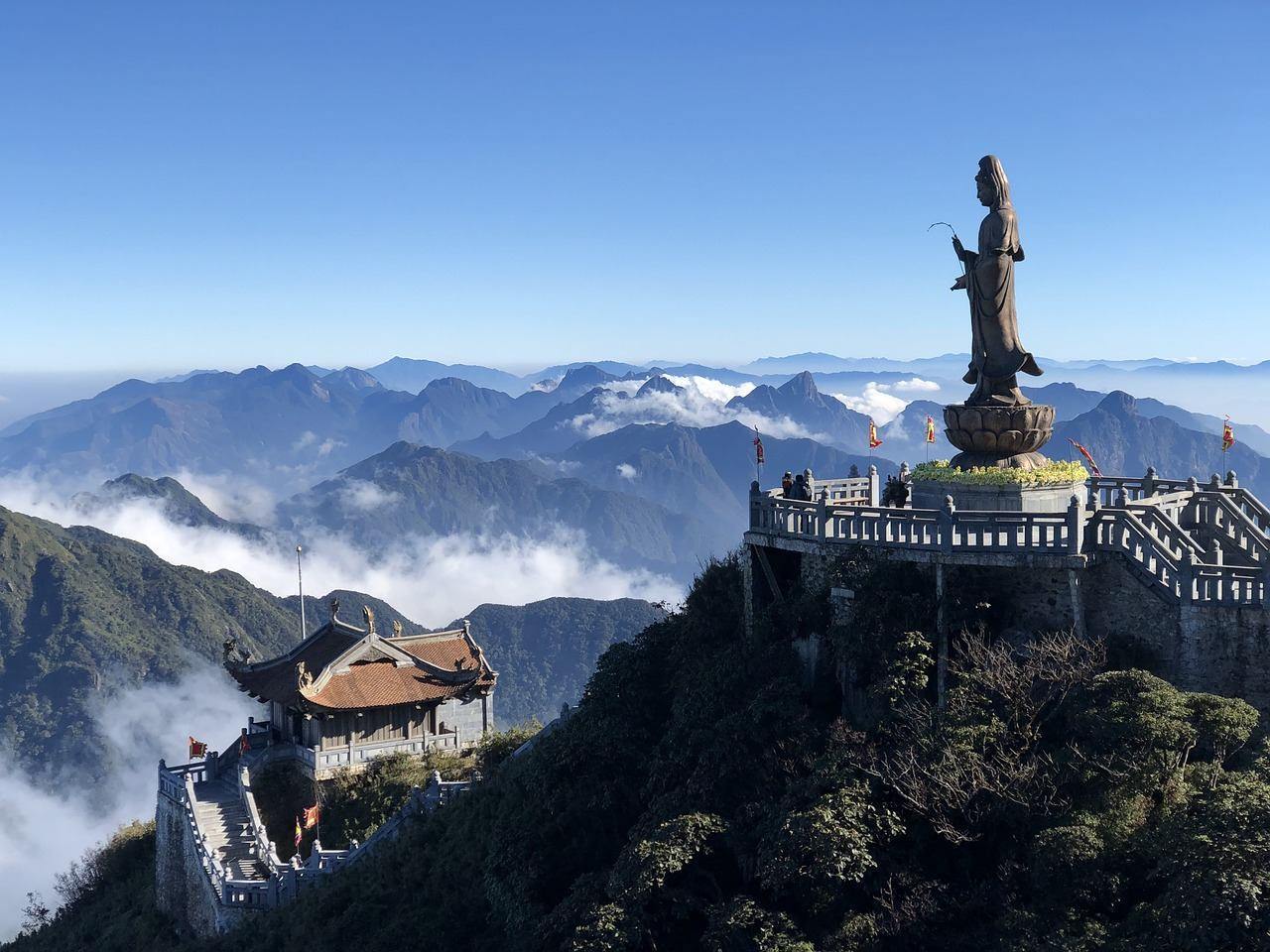 Statue at the Fansipan summit rising above the clouds